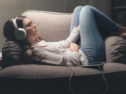 A person with headphones on, immersed in listening to affirmations for positivity and healing.